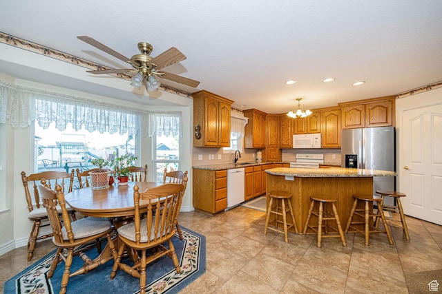2983 W 2600 N, Plain City, UT 84404 - kitchen featuring a kitchen island, a sink, ceiling fan with notable chandelier, recessed lighting, and white appliances