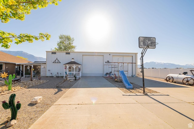 2983 W 2600 N, Plain City, UT 84404 - view of front facade with a garage, a mountain view, and concrete driveway