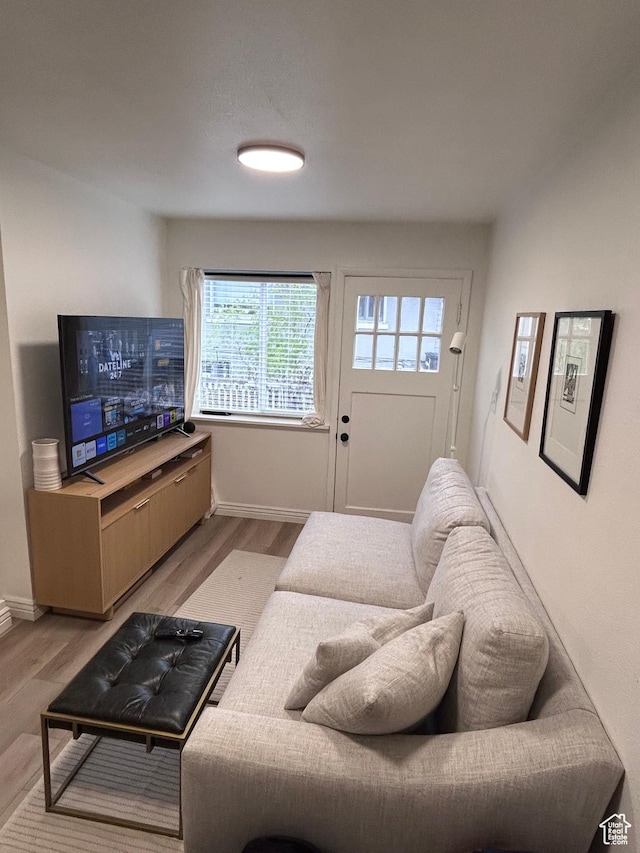 living room featuring light wood-type flooring and baseboards