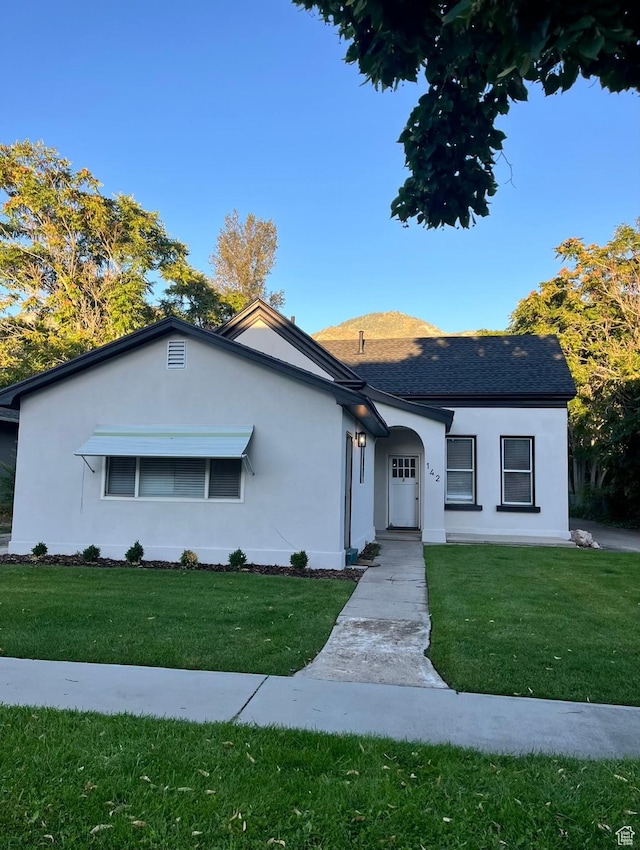 142 N 100 E, Provo, UT 84606 - ranch-style home with stucco siding, a front yard, and roof with shingles
