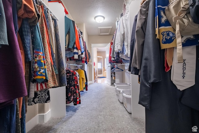 walk in closet featuring attic access
