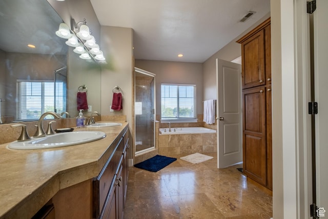bathroom featuring a garden tub, a shower stall, double vanity, and recessed lighting