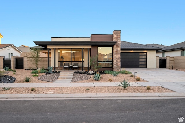 733 W Juniper Hill Dr, St George, UT 84790 - view of front of house with a garage, fence, covered porch, a gate, and concrete driveway