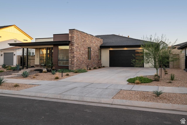 733 W Juniper Hill Dr, St George, UT 84790 - modern home with an attached garage, concrete driveway, stucco siding, and stone siding