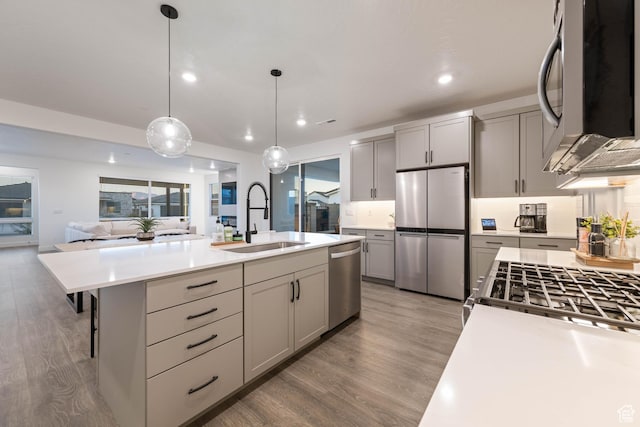 733 W Juniper Hill Dr, St George, UT 84790 - kitchen with light wood-style floors, light countertops, a sink, gray cabinetry, and stainless steel appliances
