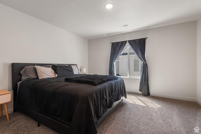 bedroom featuring baseboards, carpet, and visible vents