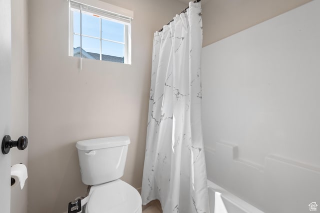 bathroom featuring toilet and a shower with curtain