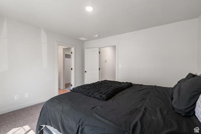 carpeted bedroom featuring baseboards