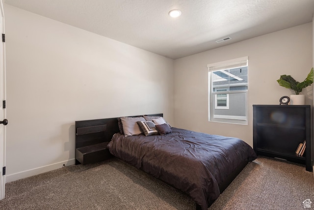 bedroom featuring carpet floors, baseboards, and visible vents