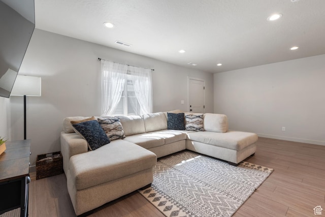 living room featuring visible vents, recessed lighting, light wood finished floors, and baseboards