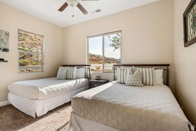 bedroom with a ceiling fan, carpet flooring, and visible vents