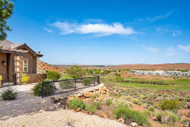 view of yard with a mountain view and fence