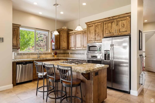 kitchen with light stone counters, decorative backsplash, recessed lighting, and stainless steel appliances