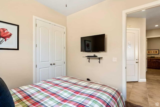 bedroom featuring recessed lighting, tile patterned floors, baseboards, and a closet