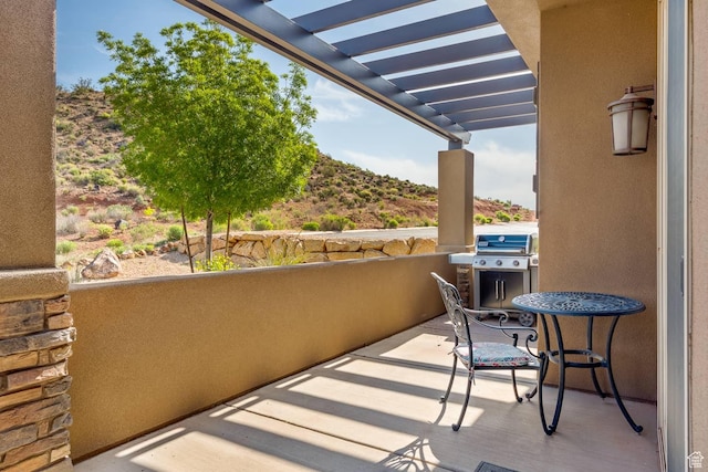 balcony featuring a pergola and area for grilling