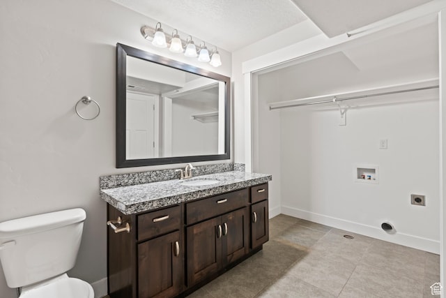 bathroom with vanity, tile patterned flooring, and toilet