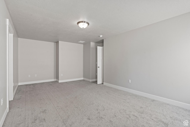 interior space featuring a textured ceiling and baseboards