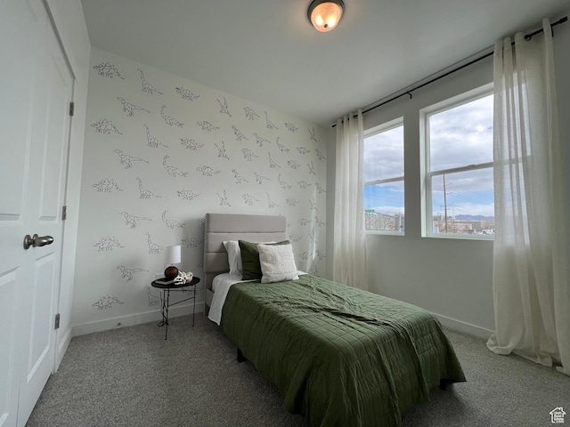 bedroom with baseboards and light carpet
