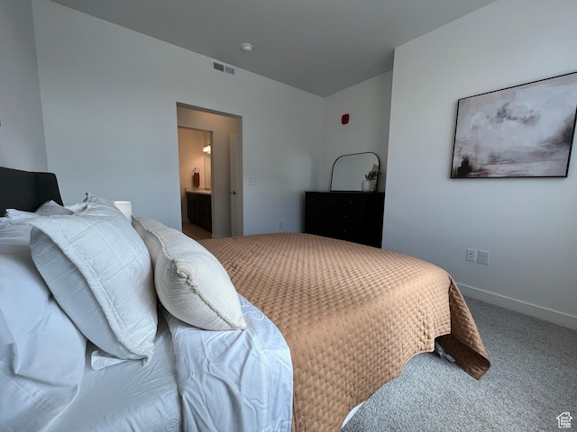 bedroom with baseboards, carpet flooring, ensuite bath, and visible vents