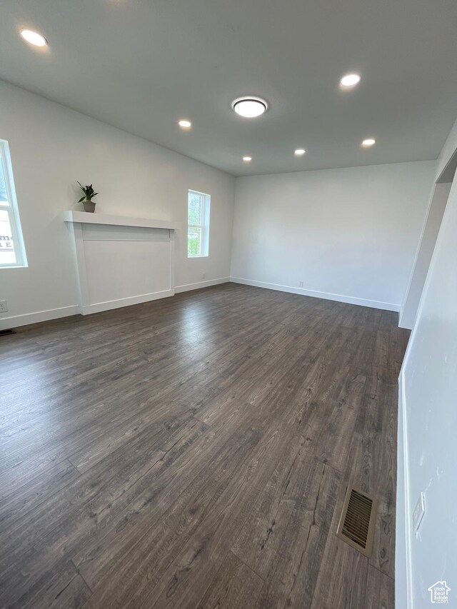 868 Washington Blvd, Ogden, UT 84404 - unfurnished living room featuring visible vents, dark wood-type flooring, and recessed lighting