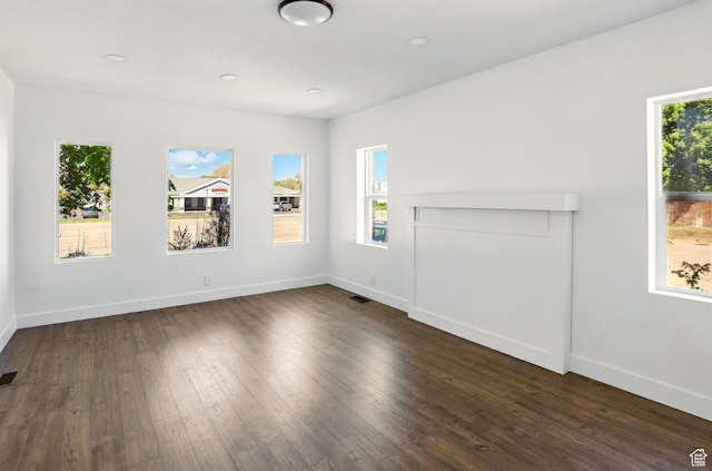 868 Washington Blvd, Ogden, UT 84404 - unfurnished living room featuring baseboards, dark wood-style flooring, and visible vents