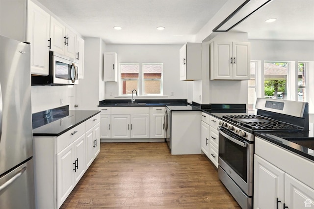 868 Washington Blvd, Ogden, UT 84404 - kitchen with a sink, white cabinets, stainless steel appliances, and a wealth of natural light