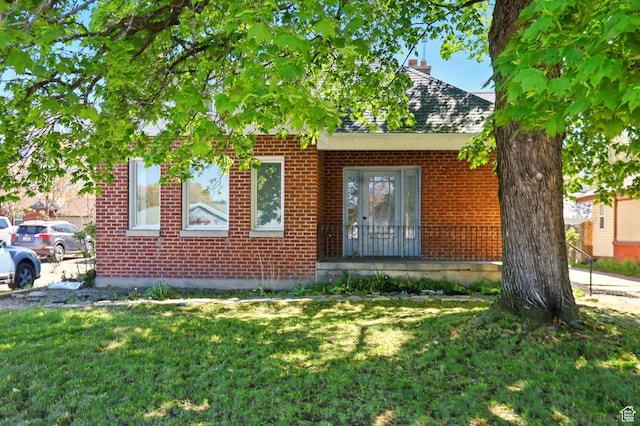 868 Washington Blvd, Ogden, UT 84404 - view of front facade featuring brick siding and a front yard