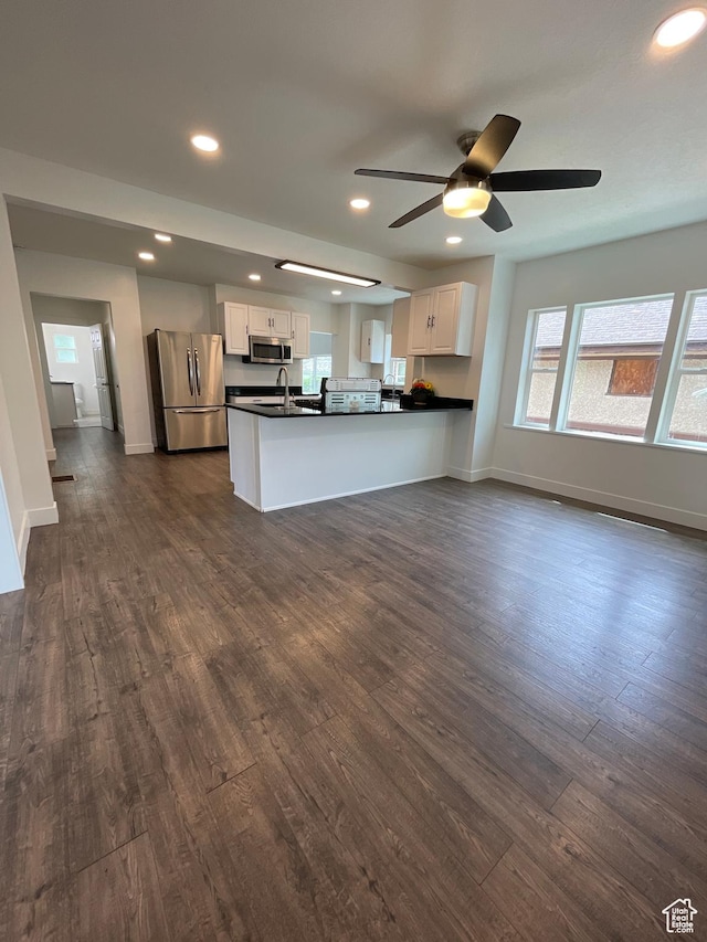 868 Washington Blvd, Ogden, UT 84404 - kitchen featuring dark countertops, appliances with stainless steel finishes, dark wood-style flooring, and white cabinetry