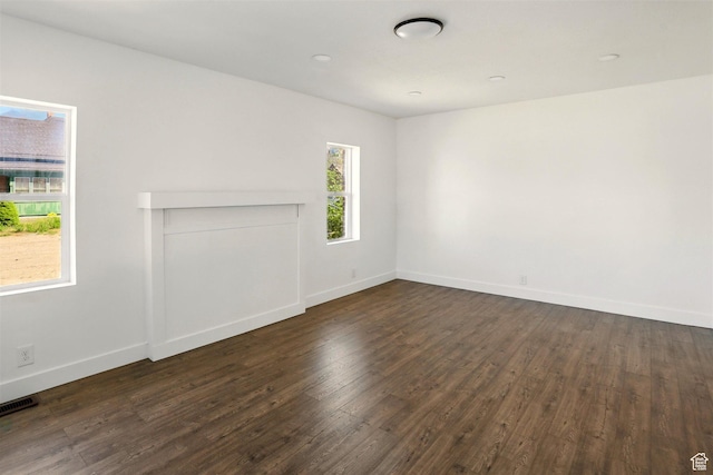 868 Washington Blvd, Ogden, UT 84404 - unfurnished living room featuring baseboards, dark wood-style flooring, and visible vents