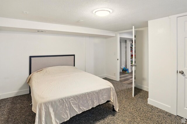 868 Washington Blvd, Ogden, UT 84404 - bedroom featuring a textured ceiling, carpet floors, baseboards, and visible vents