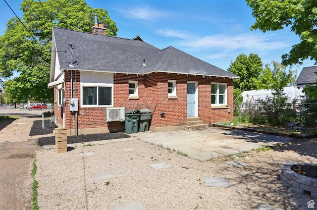 868 Washington Blvd, Ogden, UT 84404 - rear view of property featuring a chimney, brick siding, fence, a shingled roof, and entry steps