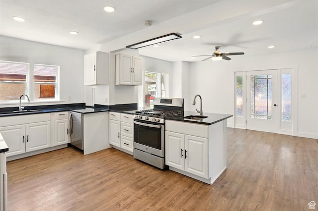 868 Washington Blvd, Ogden, UT 84404 - kitchen with stainless steel appliances, a healthy amount of sunlight, a sink, and a peninsula