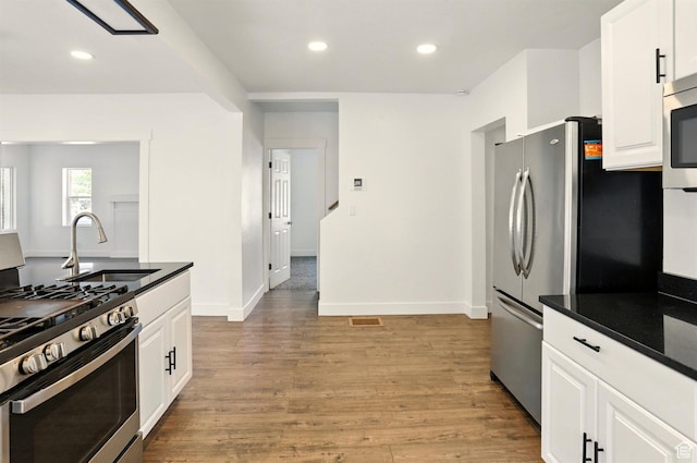 868 Washington Blvd, Ogden, UT 84404 - kitchen featuring light wood-type flooring, a sink, stainless steel appliances, recessed lighting, and white cabinetry