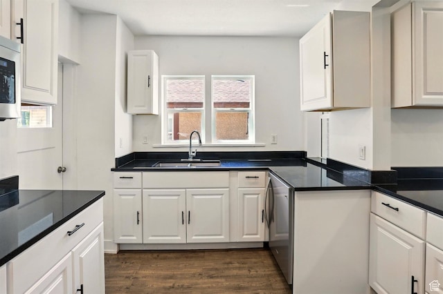 868 Washington Blvd, Ogden, UT 84404 - kitchen with white cabinets, dark countertops, dark wood-style floors, and a sink