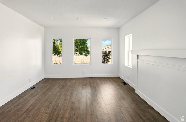 868 Washington Blvd, Ogden, UT 84404 - empty room with baseboards, dark wood-style floors, and visible vents