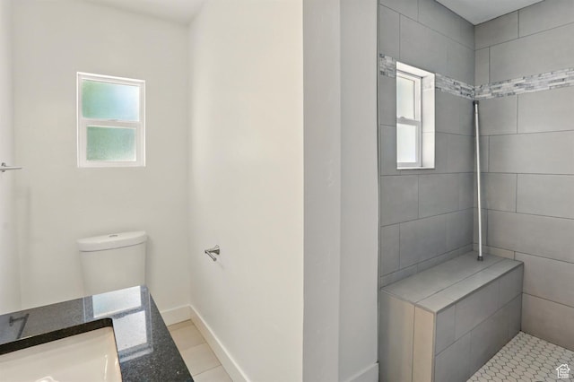 868 Washington Blvd, Ogden, UT 84404 - full bathroom with toilet, plenty of natural light, tiled shower, and tile patterned flooring