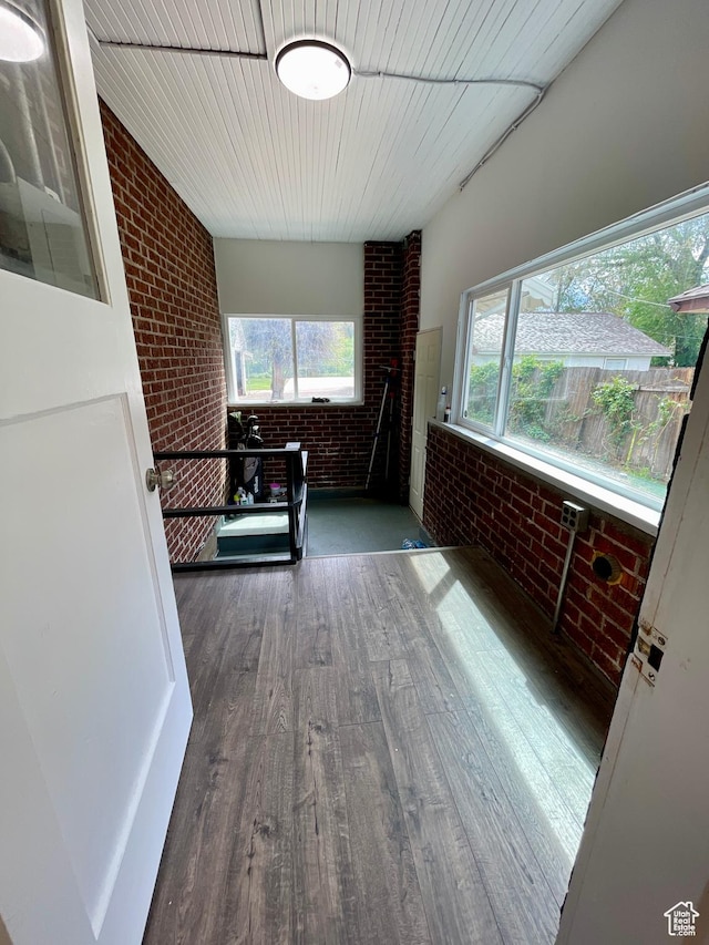868 Washington Blvd, Ogden, UT 84404 - interior space featuring brick wall, wooden ceiling, plenty of natural light, and wood finished floors