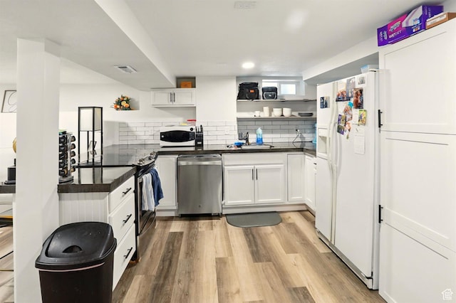 868 Washington Blvd, Ogden, UT 84404 - kitchen with white appliances, open shelves, visible vents, and dark countertops