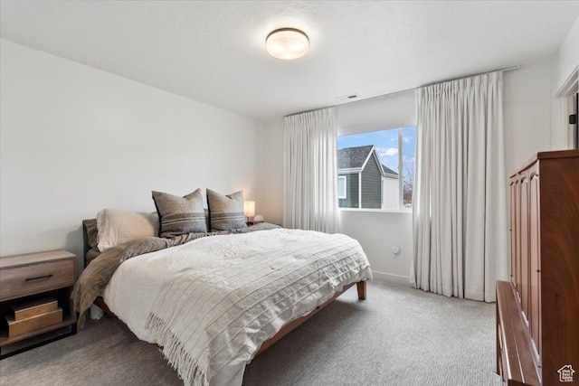 carpeted bedroom featuring visible vents