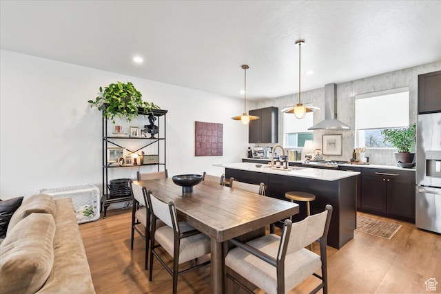 dining space featuring recessed lighting and light wood finished floors