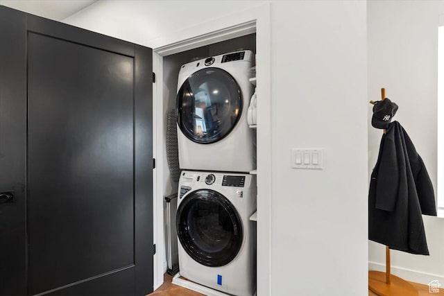 laundry room featuring stacked washer and dryer and laundry area