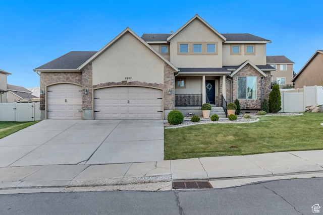 view of front of house with fence, an attached garage, stucco siding, and stone siding