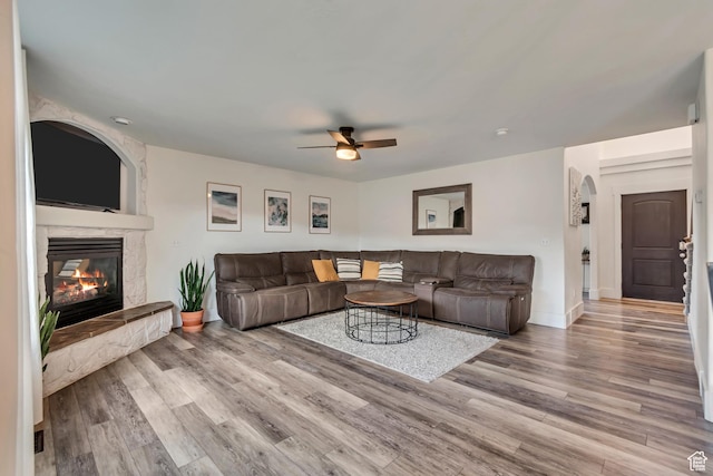8983 N Barton Creek Dr, Eagle Mountain, UT 84005 - living room with baseboards, a ceiling fan, wood finished floors, and a fireplace