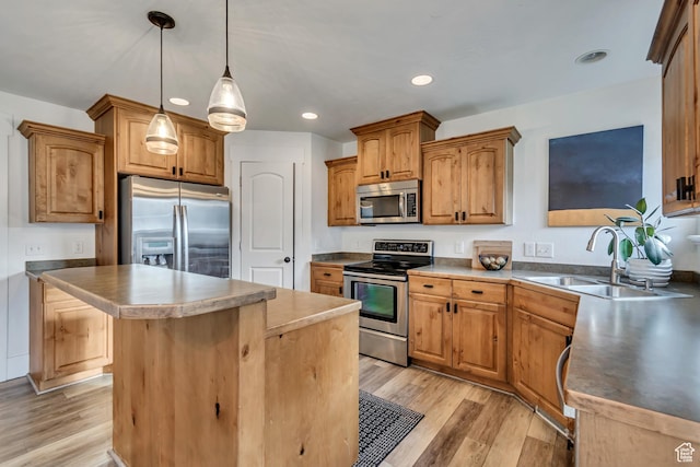 8983 N Barton Creek Dr, Eagle Mountain, UT 84005 - kitchen with a sink, light wood-style flooring, stainless steel appliances, recessed lighting, and a kitchen island