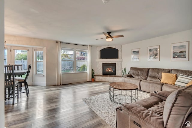 8983 N Barton Creek Dr, Eagle Mountain, UT 84005 - living room featuring a ceiling fan, baseboards, wood finished floors, and a fireplace