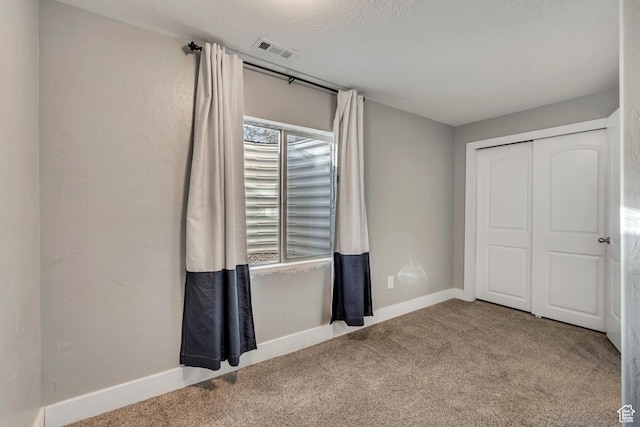 8983 N Barton Creek Dr, Eagle Mountain, UT 84005 - unfurnished bedroom featuring visible vents, baseboards, carpet floors, and a closet