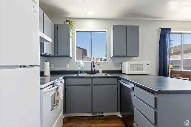 320 E Clark St, Grantsville, UT 84029 - kitchen with white appliances, a peninsula, gray cabinetry, and a sink