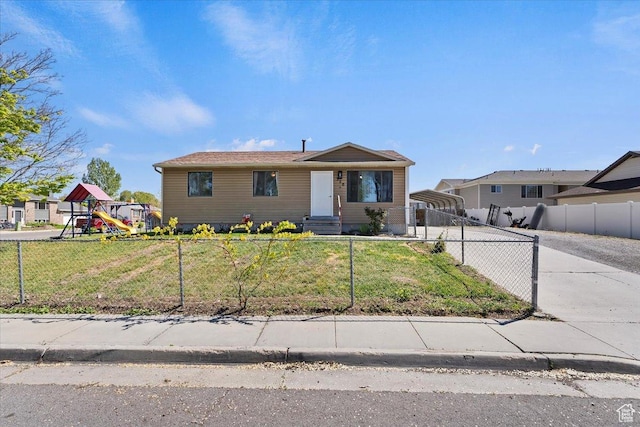 320 E Clark St, Grantsville, UT 84029 - view of front of house with a detached carport, a fenced front yard, and a front yard