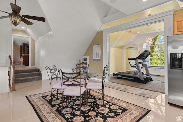 tiled dining space featuring ceiling fan with notable chandelier, recessed lighting, and lofted ceiling
