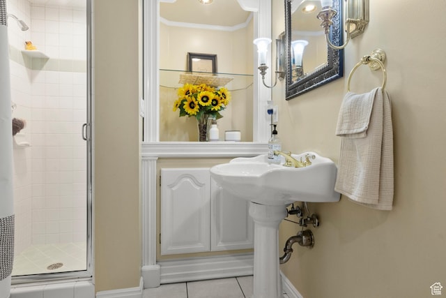 full bath featuring baseboards, tile patterned floors, a stall shower, and ornamental molding